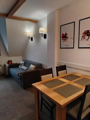 a living room with a table and a couch at Kopaonik Župa 505 in Kopaonik