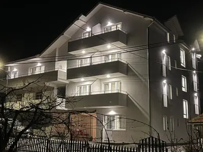 a building at night with lights on at Milutinn-Lipa in Soko Banja