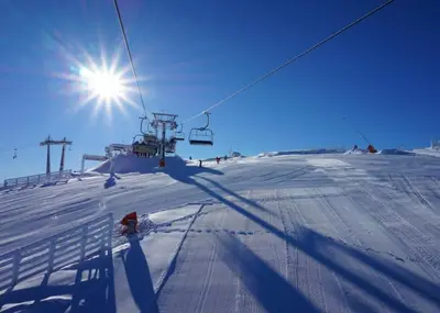 a person riding a ski lift in the snow at Milmari Resort Lux H-1 in Kopaonik