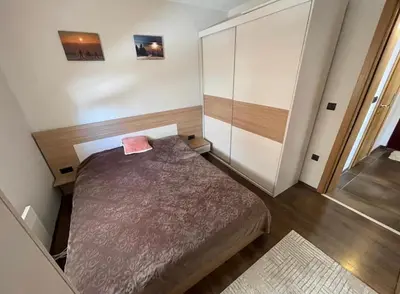 a small room with a bed and a cabinet at Milmari Resort Lux H-1 in Kopaonik
