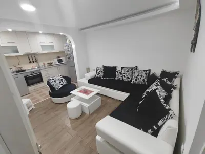 a living room with a couch and a table at Bilja's house in Niš