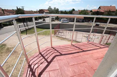 a metal railing on a porch with a view of a street at Vurk INN Paracin in Paraćin