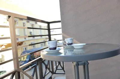 a table on a balcony with two cups on it at Stan na dan Raška in Raška