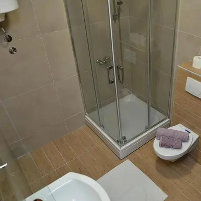 a bathroom with a shower stall and a toilet at Stan na dan Raška in Raška