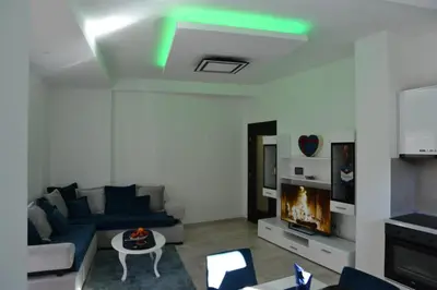 a living room with a blue couch and a fireplace at Stan na dan Raška in Raška