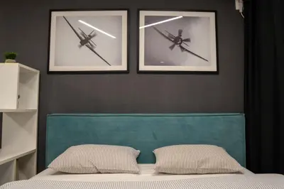 a bedroom with two pictures of planes on the wall at Mac Aviator City Center Two Double Bed Apartment in Niš