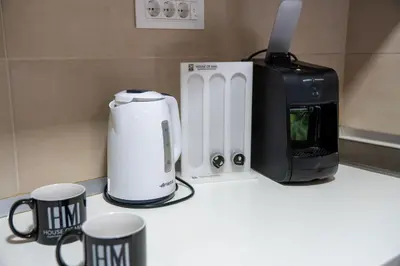 a coffee maker and a toaster on a counter at Mac Aviator City Center Two Double Bed Apartment in Niš
