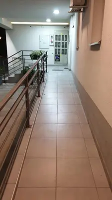 a hallway in a building with a hallway at Mac Aviator City Center Two Double Bed Apartment in Niš