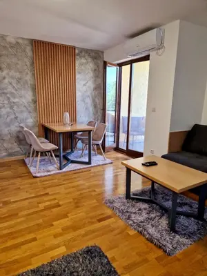 a living room with two tables and a couch at Apartman FiliAki in Vrnjačka Banja