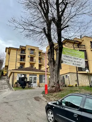 a car parked in front of a building with a sign at Apartman FiliAki in Vrnjačka Banja