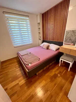 a bedroom with a large bed and a window at Apartman FiliAki in Vrnjačka Banja