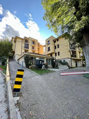 a yellow and black striped sign in front of a building at Apartman FiliAki in Vrnjačka Banja