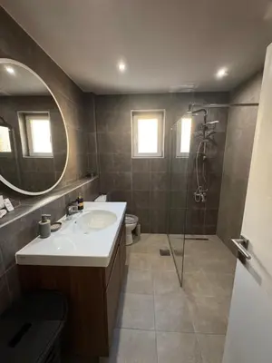 a bathroom with a sink and a shower with a mirror at Lala Lux & Parking free in Soko Banja