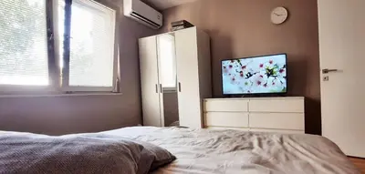 a bedroom with a bed and a flat screen tv at Lala Lux & Parking free in Soko Banja