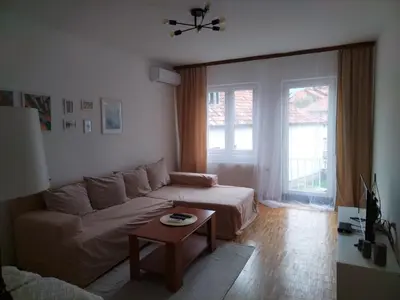 a living room with a couch and a table at Holiday House in Zaječar