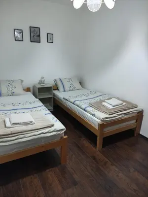 two beds sitting next to each other in a room at Holiday House in Zaječar