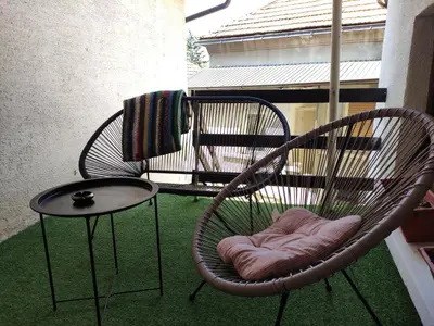 a chair and a table on a balcony at Holiday House in Zaječar