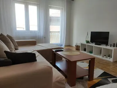 a living room with a couch and a table at Holiday House in Zaječar