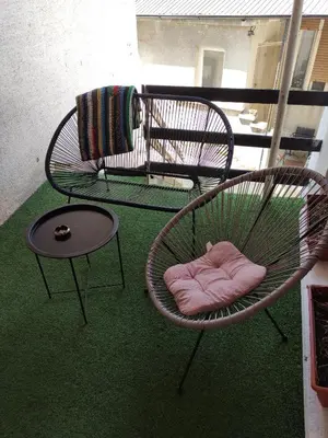 a chair and a table on a balcony at Holiday House in Zaječar