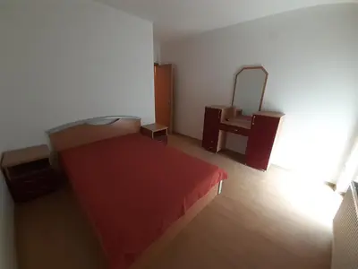 a bedroom with a red bed and a mirror at Apartman Nole 1 in Despotovac