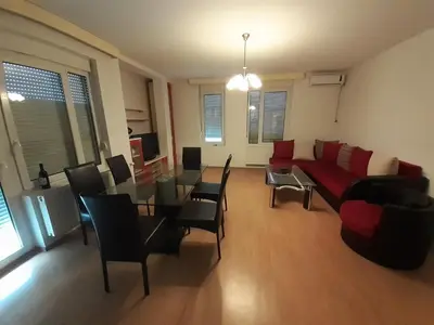 a living room with a couch and a table and chairs at Apartman Nole 1 in Despotovac