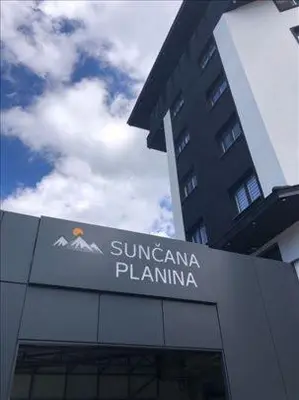 a sign on the side of a building at Apartman Skyline Kopaonik in Kopaonik