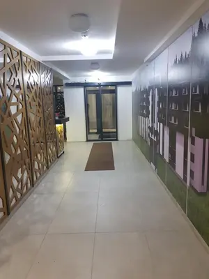 a hallway with art on the walls and a tile floor at Apartman Skyline Kopaonik in Kopaonik