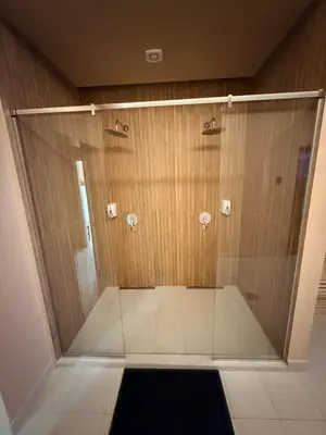 a shower with a glass door in a bathroom at Apartman Skyline Kopaonik in Kopaonik