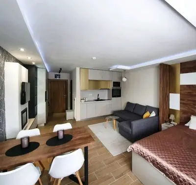 a living room with a couch and a table in a room at Apartman Skyline Kopaonik in Kopaonik