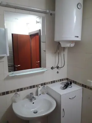 a bathroom with a sink and a mirror at VILA BJANKA 205 in Kopaonik