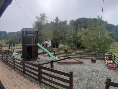 a park with a playground with a slide at Apartman Popadić-Goč in Biserske Kuće