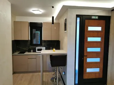 a kitchen with a door and a table and a counter at EHINACEA in Rtanj