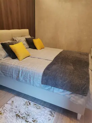 a bed with two yellow pillows on top of it at EHINACEA in Rtanj