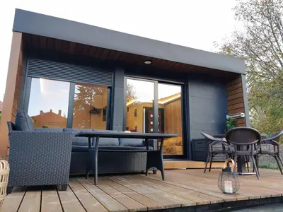 a patio with a table and chairs on a deck at EHINACEA in Rtanj