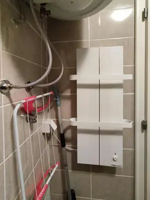 a bathroom with white shelves on the wall at Magic Dream Lux apartman in Vrnjačka Banja