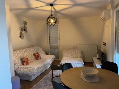 a living room with a couch and a table at Apartman I&V in Vrnjačka Banja
