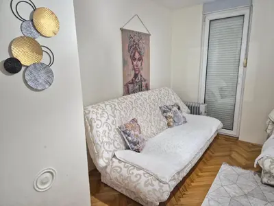 a living room with a couch and a painting on the wall at Apartman I&V in Vrnjačka Banja