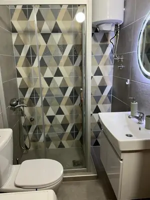 a bathroom with a shower and a toilet and a sink at Apartman I&V in Vrnjačka Banja