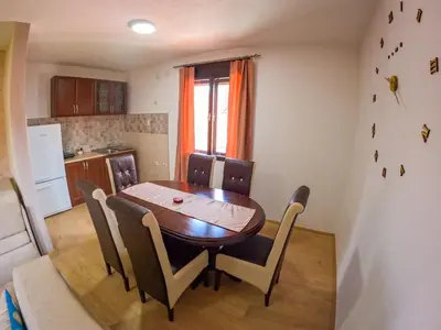 a dining room table and chairs in a kitchen at Beli Ocnjak in Soko Banja