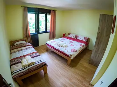 a small bedroom with a bed and a window at Beli Ocnjak in Soko Banja