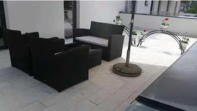 a room with chairs and a table and a pole at M & M in Vrnjci