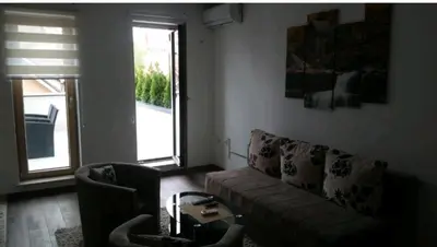 a living room with a couch and a table at M & M in Vrnjci