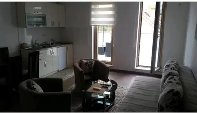 a living room with a couch and two chairs and a table at M & M in Vrnjci