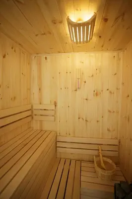 a wooden sauna with a light on the ceiling at Vila Oaza mira Draganići in Raška