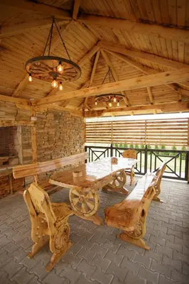 a room with a wooden table and benches in a cabin at Vila Oaza mira Draganići in Raška