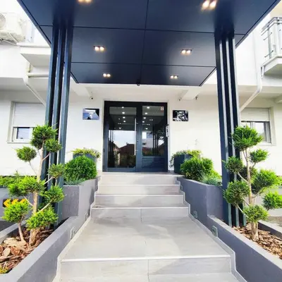 an office building with a staircase leading to the front door at VIP Apartment in Jagodina