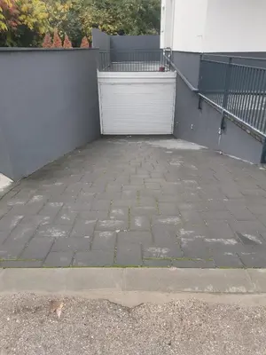 a brick patio with a white door on a building at VIP Apartment in Jagodina