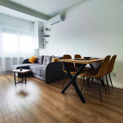 a living room with a table and a couch at VIP Apartment in Jagodina