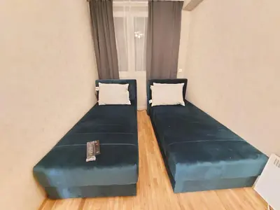 two beds in a room with blue cushions at KATARINA - Lux two bedroom apartment in ski resort Kopaonik in Kopaonik