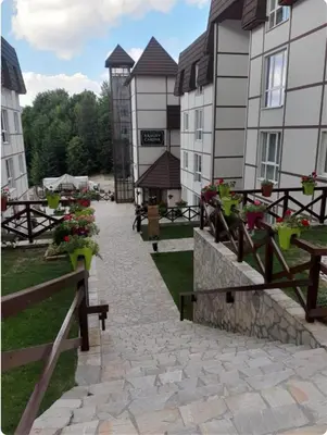 a walkway in front of a building with potted plants at KATARINA - Lux two bedroom apartment in ski resort Kopaonik in Kopaonik
